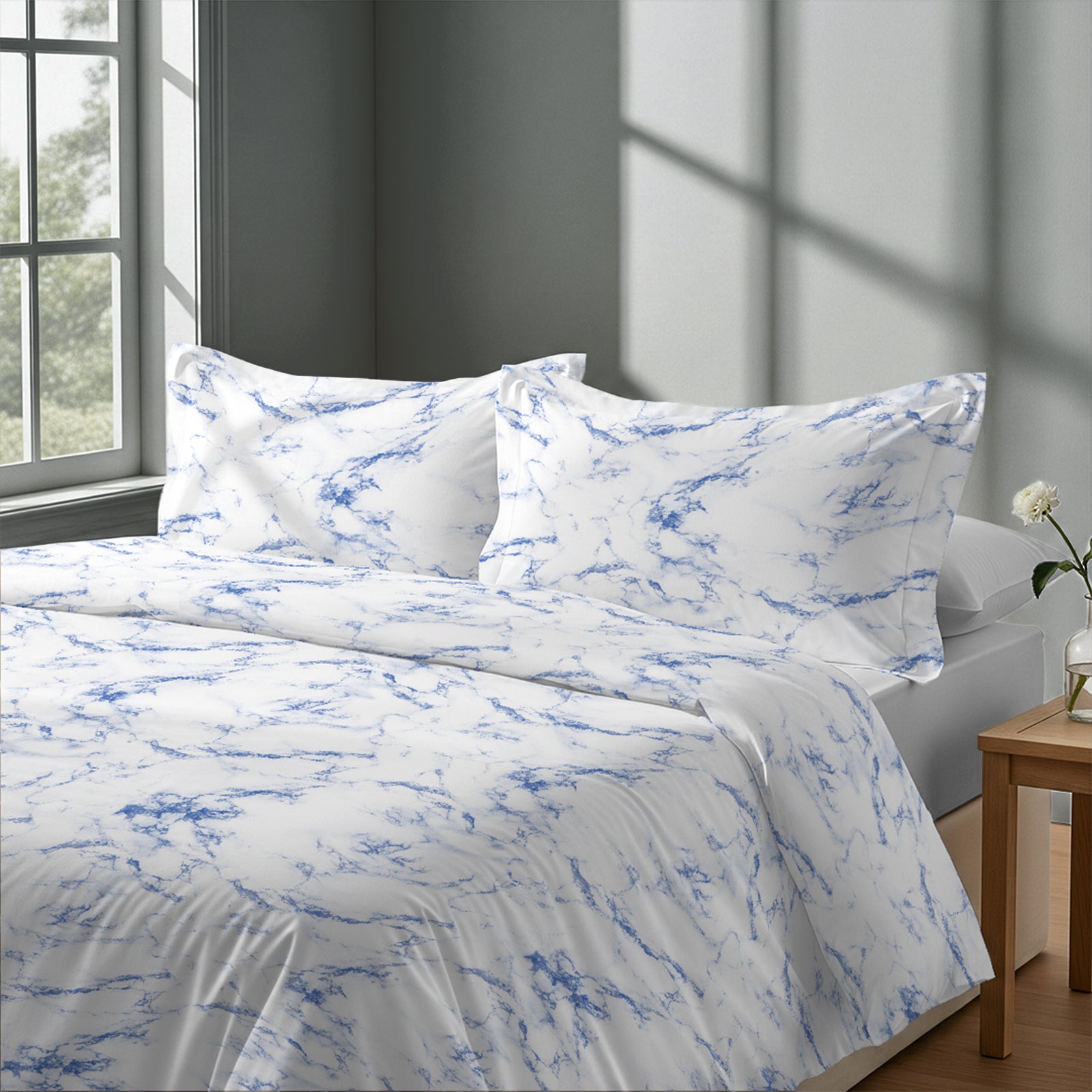 Calm luxurious bedroom bed with Carrara Marble Blue Pizuna Linens cotton duvet cover super king size